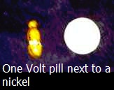 One Volt pill next to a nickel