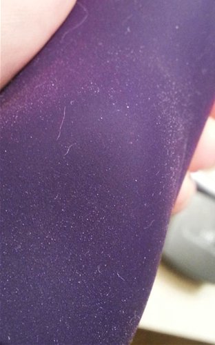 There are a few fibers, but the flecks are actually silicone and not lint.