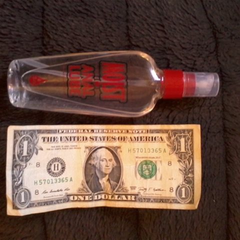 4 oz. bottle next to $1.00 bill size comparison