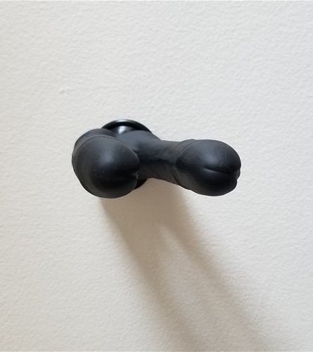 Front view of demon suction-cupped to wall